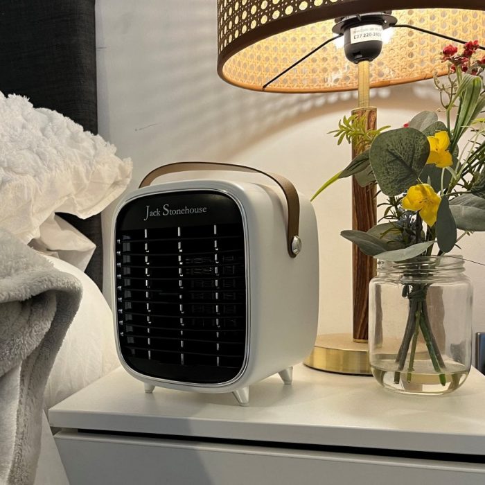 A small portable heater on a bedside table.