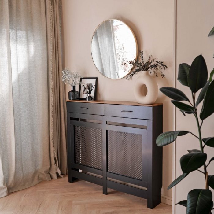 A black radiator cover in a modern hallway.