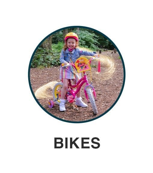 Little girl on a pink kids bike