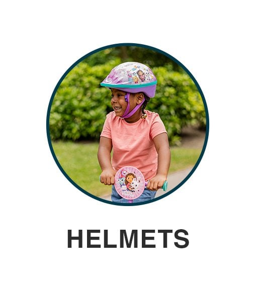 Little boy wearing a safety helmet on a scooter